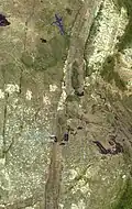 The Zimbabwe Great Dyke: A big band of igneous rock cuts between sedimentary rocks. This picture was taken from a satellite.